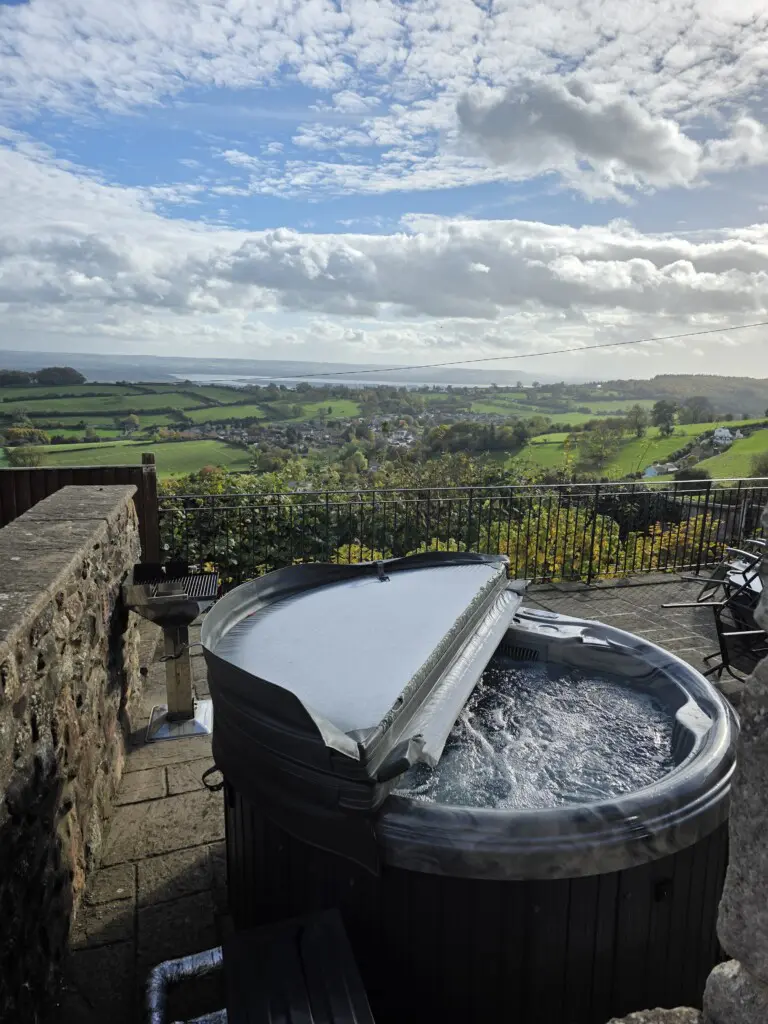 Bubbling hot tub with countryside background