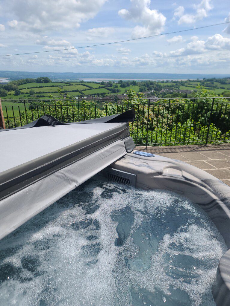 bubbling hot tub and countryside views at Woodland Barn
