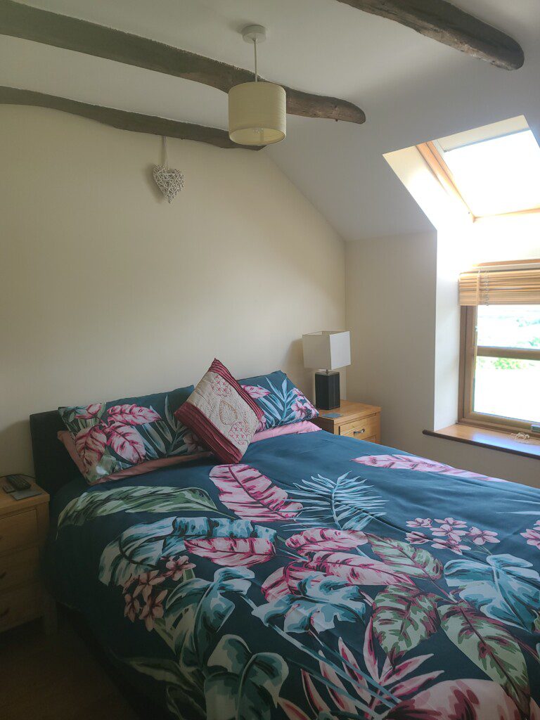 King bedroom with leaves bedding at Woodland Barn